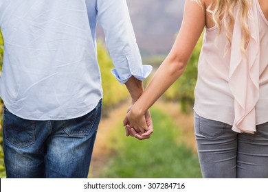 Young happy couple holding hands in the grape fields - Powered by Shutterstock