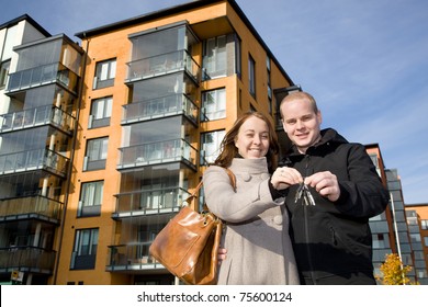 Young Happy Couple Holding Keys To Their New Home