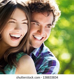 Young Happy Couple Hugging And Laughing.