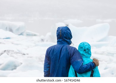 Young Happy Couple Looking At View During Hike In Iceland