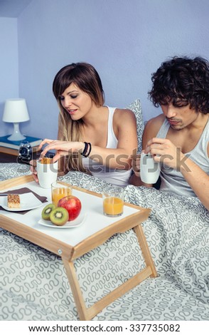 Similar – Gesundes Frühstück auf Tablett und im Hintergrund liegendes Paar