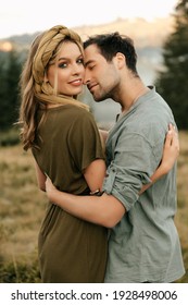 Young happy couple in love hugging smiling and having fun in the mountains. High quality photo