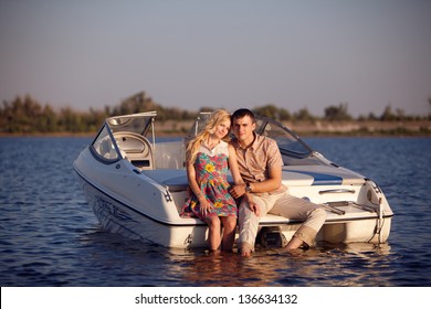 Young Happy Couple On The Boat