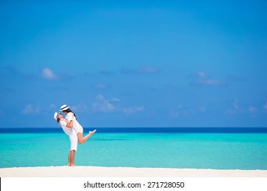Young happy couple on white beach at summer vacation