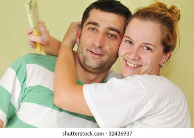 Young Happy Couple Painting Their New Home Interior