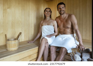 young happy couple relaxing in sauna. romantic spa getaway. copy space