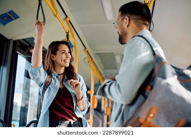 Young happy couple talking while commuting by bus. Focus is on woman. - Powered by Shutterstock