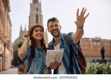 Young happy couple using map while sightseeing during their trip. - Powered by Shutterstock