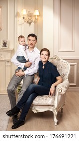 Young Happy Family With A Baby Indoors