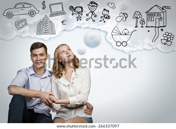 Young\
happy family couple dreaming of future wealthy\
life
