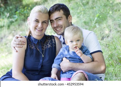 Young happy family the park - Shutterstock ID 452953594