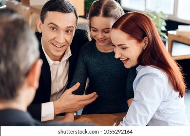 Young Happy Family Received Cash Compensation For Something In Lawyer's Office. Concept Of Property Division Under Divorce. Family In Office Of Family Lawyer.