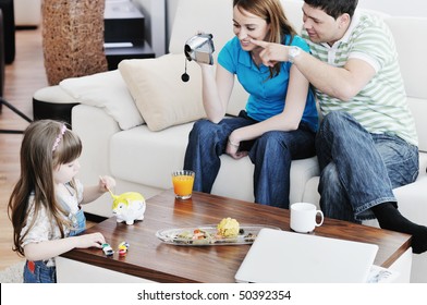 Young Happy Family Recording By Video Camera Their Child At Home