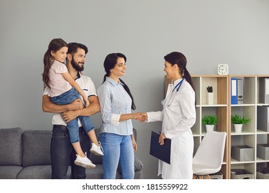 Young Happy Family With Small Daughter Saying Goodbye To Woman Doctor And Shaking Hands After Successful Visit In Medical Clinic Office. Family Visiting Doctor In Hospital Concept