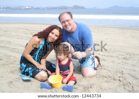 Young happy family together on the beach