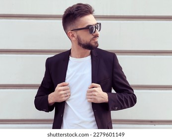 A young happy fashionable man posing outside. High quality photo - Shutterstock ID 2279601149