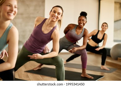 Young happy female athlete warming up with group of women on exercise class at health club. - Powered by Shutterstock