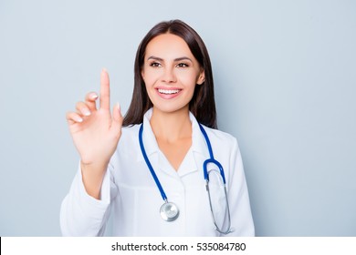 Young Happy Female Doctor Touching Virtual Screen