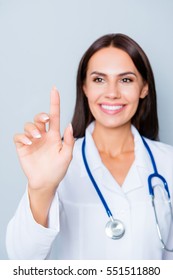 Young Happy Female Doctor Touching Virtual Screen