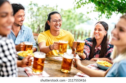 Young Happy Friends Drinking And Toasting Beer At Brewery Bar Restaurant Patio - Beverage Life Style Concept With Men And Women Having Fun Together Out Side - Bright Vivid Filter With Focus On Mid Guy