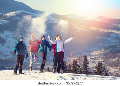 Young Happy Friends Having Fun In Winter Mountains