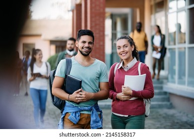 Young happy friends standing outside of university building after the lecture. - Shutterstock ID 2145158317