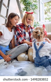 Young Happy Gay Family Woman Moving In New House
