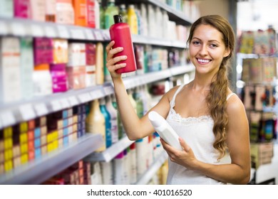 Young Happy  Girl Buying Shampoo In Shopping Mall
