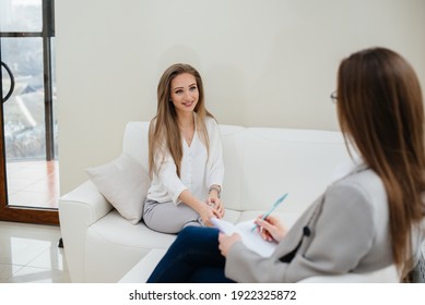 A Young Happy Girl Communicates With A Psychologist In A Modern Office. Psychological Help.