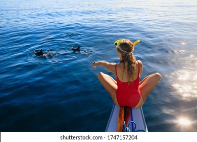 Young Happy Girl In Snorkeling Mask Sit No Boat. Dolphins Watching Adventure Tour On Tropical Islands. Water Activity, Active Children Lifestyle, Summer Vacation Travel With Kids At Family Resort.