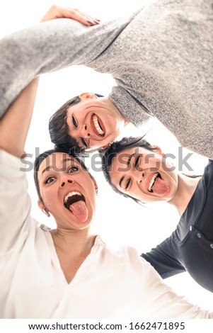 young and happy girls shot from below make their tongues closed in a circle
