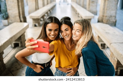 Young happy group of multiracial best women friends taking selfie portrait on cellphone app during summer vacation in Italy. Youth, travel and female friendship concept - Powered by Shutterstock