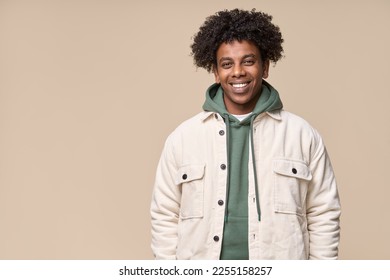 Young happy hipster African American teen guy isolated on pastel beige background. Smiling cool curly ethnic generation z teenager student model standing looking at camera posing for portrait. - Powered by Shutterstock