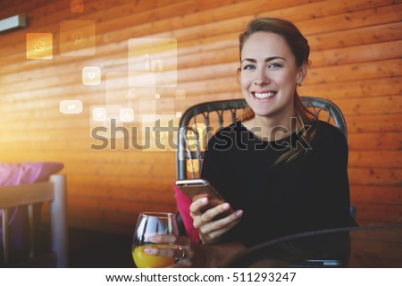 Young happy hipster girl with mobile phone in hands looking to the camera.Cheerful female student using cell telephone. Infographics design elements of popular social network application and programs