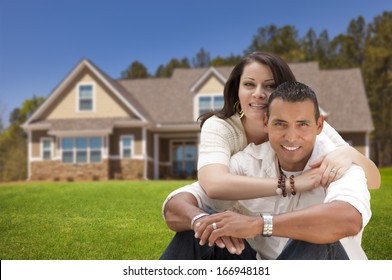 Young Happy Hispanic Young Couple in Front of Their New Home. - Powered by Shutterstock