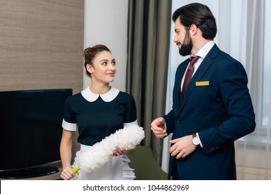 Young Happy Hotel Service Staff Talking At Suite