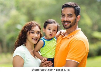 Young Happy Indian Family With The Kid Outdoors