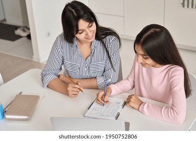 Young Happy Indian Mother Helping Teen Daughter Remote Studying At Home Explaining Doing Homework Together. Parent Mom Teaching Teenage School Child Distance Learning Online Virtual Class On Computer.