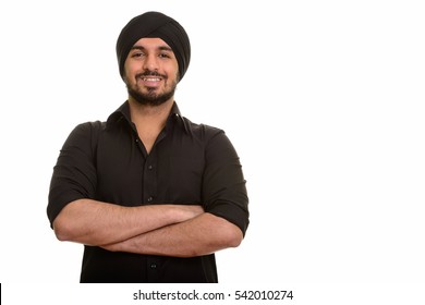 Young happy Indian Sikh man smiling isolated against white background