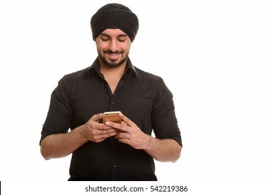 Young Happy Indian Sikh Man Using Mobile Phone Isolated Against White Background