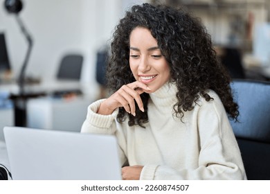 Young happy latin business woman company worker sitting in office working laptop tech  Smiling female professional sales marketing manager using corporate services computer browsing internet 