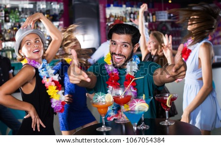 Young happy male is having fun on the hawaiian thematic party.