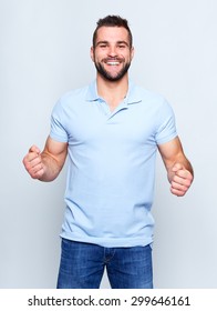 Young Happy Man In A Blue Polo Shirt