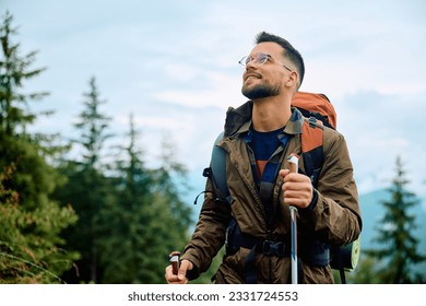 Young happy man hiking in the mountains. Copy space. - Powered by Shutterstock