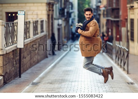 Similar – Young bearded man jumping in urban street