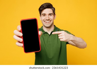 Young happy man wears green t-shirt casual clothes hold in hand use point finger on close up mobile cell phone with blank screen workspace area isolated on plain yellow background. Lifestyle concept - Powered by Shutterstock