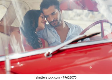 Young Happy Man And Woman Dating In Red Convertible Vintage Car From The 50s In Havana, Cuba. Horizontal Shape