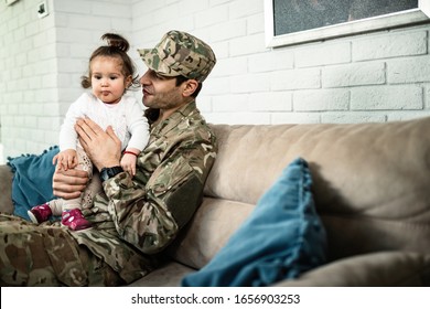 Young Happy Military Man Spending Time With His Small Daughter After Coming Home From War. 