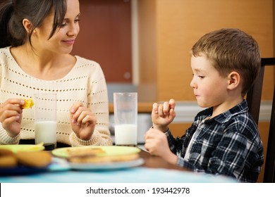 Young Happy Mother And Her Child Eating Healthy Breakfast 