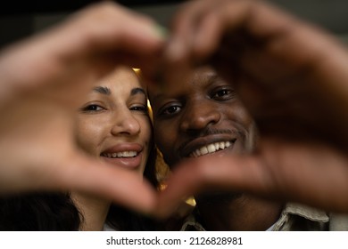 Young Happy Multi-ethnic Couple Folds Fingers Making Shape Of Heart. Biracial Woman And African American Man Show Love Looking In Camera And Smiling Closeup